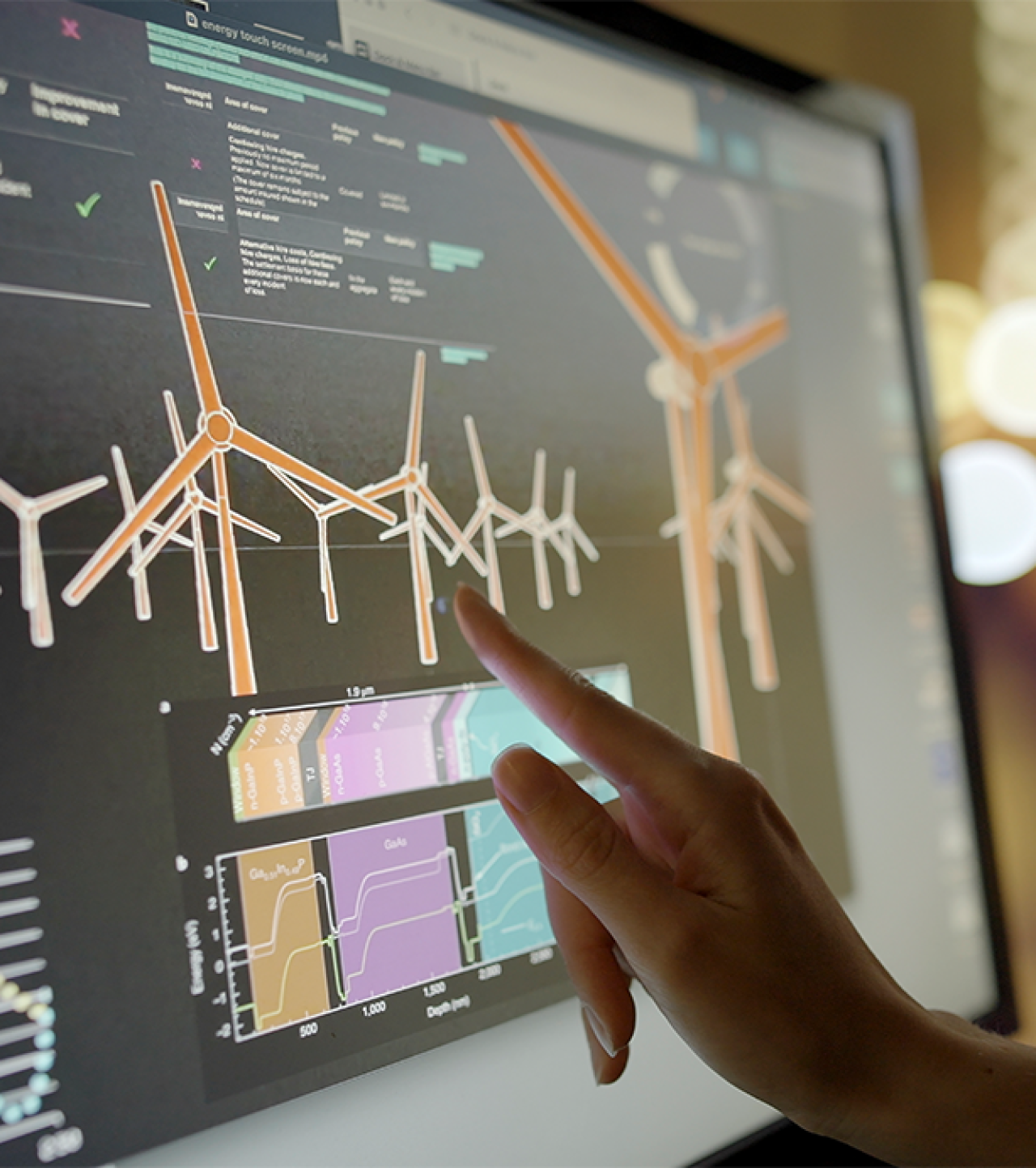 Female finger touching energy information on a screen.