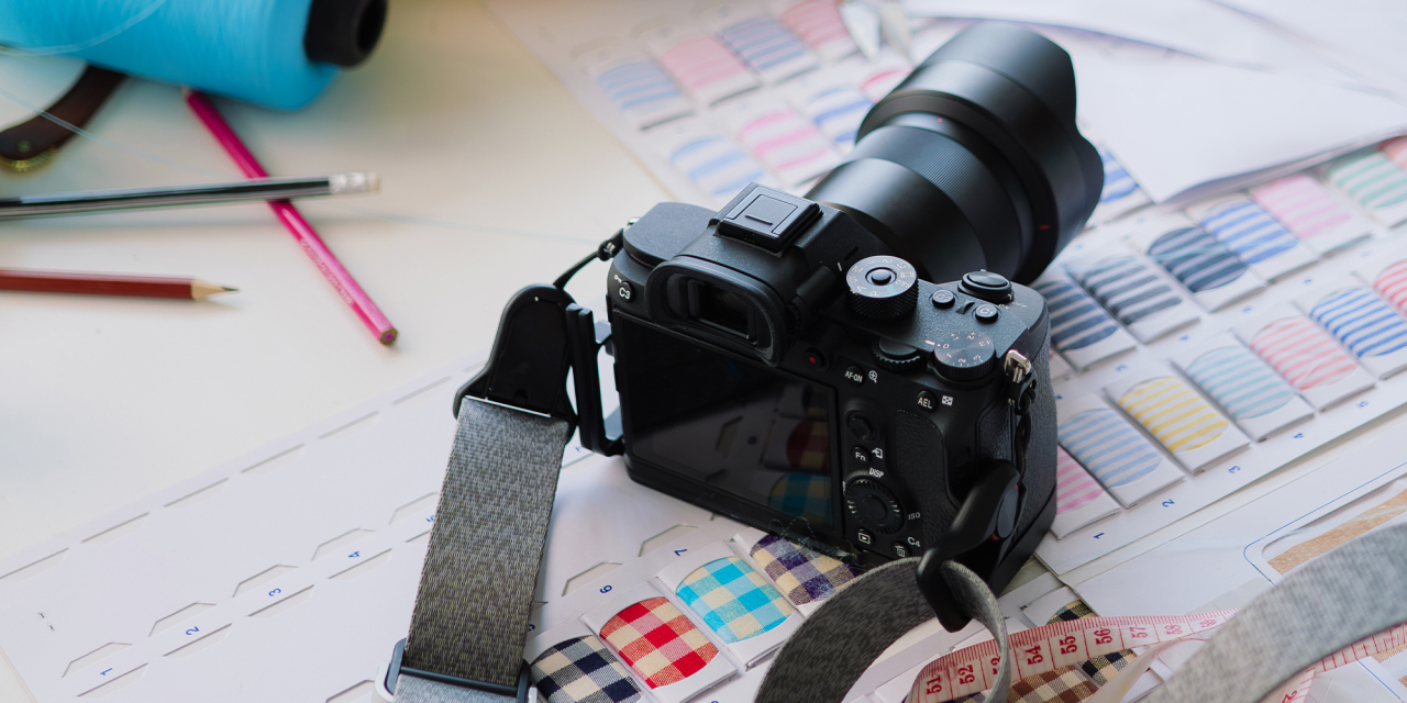 Camera sat on top of textile sample books.